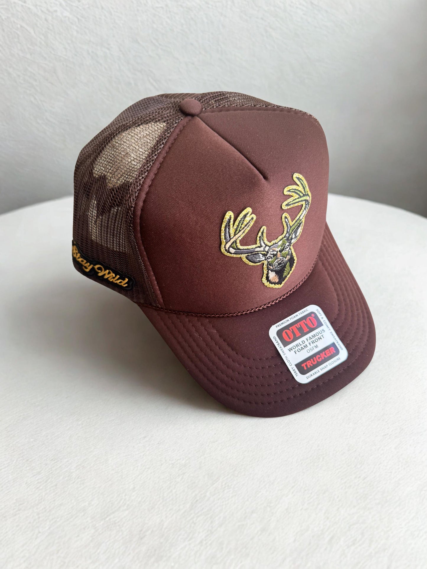 Camo deer head brown trucker patch hat with stay wild side patch